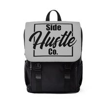 Load image into Gallery viewer, side hustle co black backpack with classic front flap with a knockout logo
